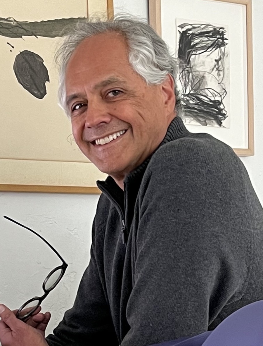 Henri Colt smiling in front of abstract artwork